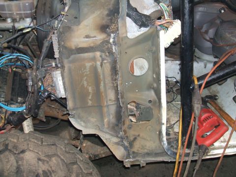 1995 Ford Bronco - Vehicle frame undergoing repair, with visible wiring and structural components.
