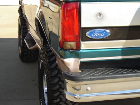 1996 Ford Bronco - Close-up of the rear of a Ford pickup truck, showing the taillight and the Ford emblem on the tailgate.