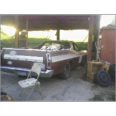 1972 Ford Ranchero - A 1972 Ford Ranchero is seen parked under a shelter, showing its rear end and side profile.