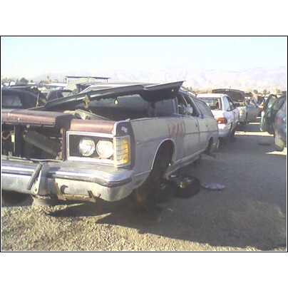 1972 Ford Ranchero - Junkyard scene with a damaged 1977 Ford LTD Country Squire wagon in the foreground.