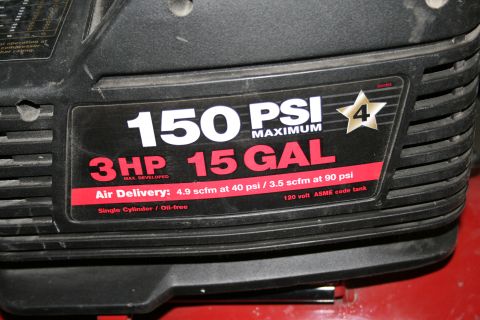 2003 Jeep TJ - Label on an air compressor details its maximum PSI, horsepower, gallon capacity, and air delivery rates at different pressures.