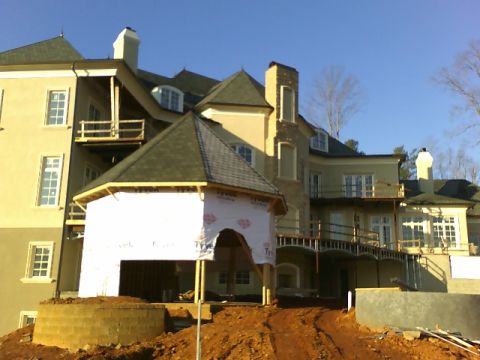 1979 Ford Ranchero - A large house is under construction, with scaffolding and building materials visible on the grounds.