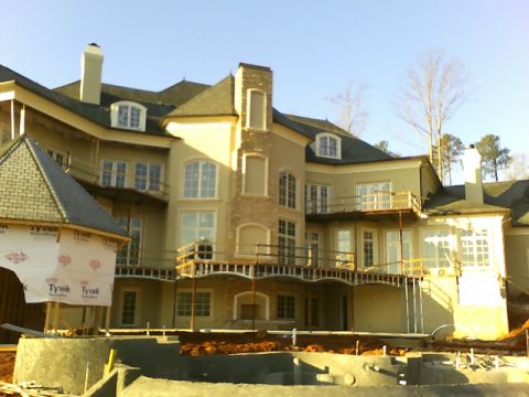 1979 Ford Ranchero - Exterior view of a large house during construction, showing unfinished elements and wrapped sections.