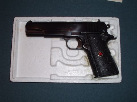1995 Mercury Grand Marquis - A black Colt Delta Elite pistol rests in a molded white foam insert.
