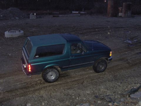 1996 Ford Bronco - The 1996 Ford Bronco is seen from a rear three-quarter angle on a dirt lot at dusk.