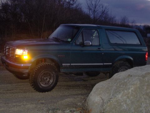 1996 Ford Bronco - 1996 Ford Bronco parked off-road at dusk.