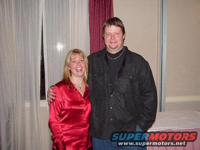 1993 Ford Bronco - Couple poses for a photo indoors with a watermark visible in the lower right corner.