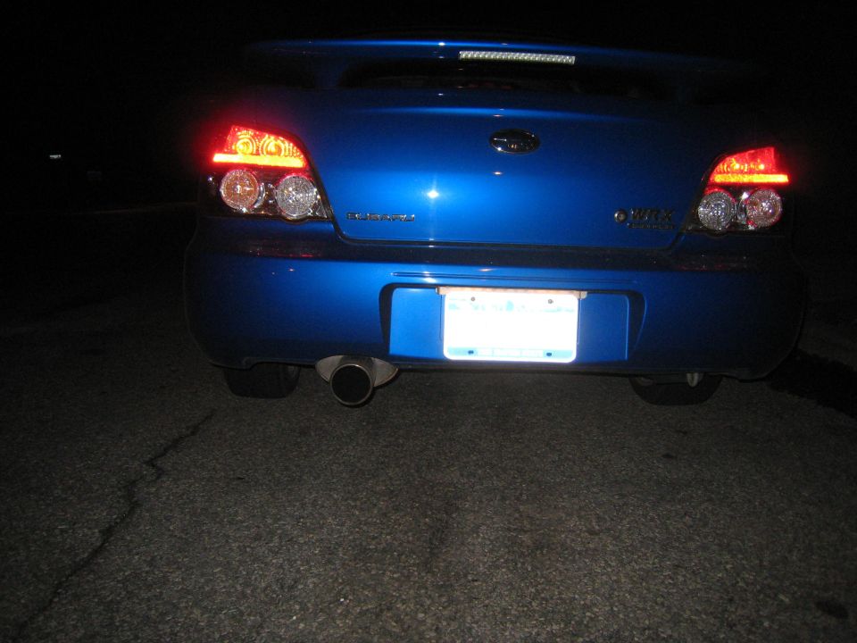 Rear of a blue Subaru Impreza WRX at night