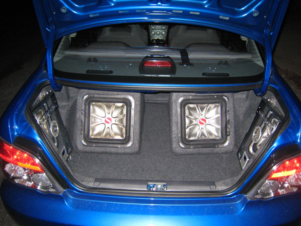 Blue Subaru Impreza trunk interior with two square subwoofers and side speakers