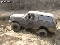 1996 Ford Bronco - This Ford Bronco is navigating a challenging off-road terrain.