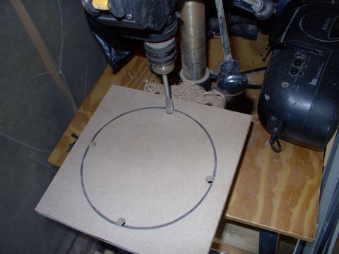 1986 Ford Bronco - Drill out four holes to ease access for your jigsaw. The MDF is 10 1/4" square and starts out as 3/4" thick.
