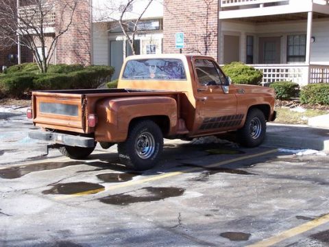 1979 Chevrolet C/K Pickup - Brown 1977 Chevrolet C/K pickup truck seen from the rear 3/4 angle in a parking lot.