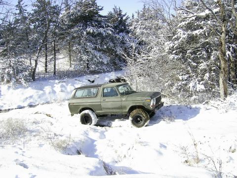 1978 Ford Bronco - A 1978 Ford Bronco navigates a snowy, wooded terrain.