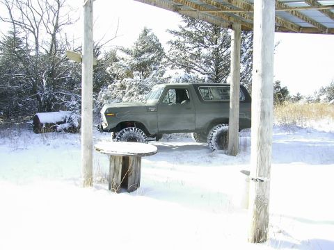 1978 Ford Bronco - 1978 Ford Bronco sits under a shelter during a snowfall, its tires ready for the snow.