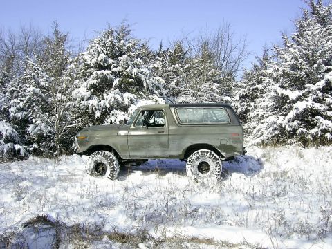 1978 Ford Bronco - A 1978 Ford Bronco navigates a snow-covered, wooded area.