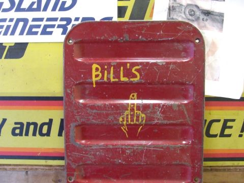 1978 Ford F-250 - Red metal part with yellow writing and a hand gesture drawing. No vehicle visible.