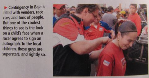 1990 Ford Bronco - A racer signs an autograph for a child at an event in Baja.