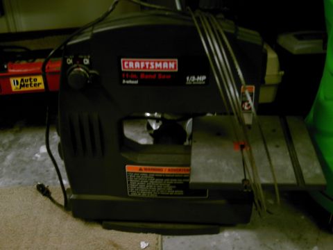 1986 Ford Bronco - A black Craftsman band saw is shown with its blades and power cord.