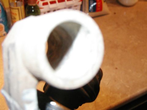 1993 Ford Bronco - A close-up of a white metal part, possibly from a vehicle's interior, is shown against a blurred background.