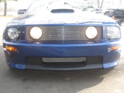 2007 Ford Mustang - Front view of a blue 2007 Ford Mustang, showing its distinctive grille and headlights.