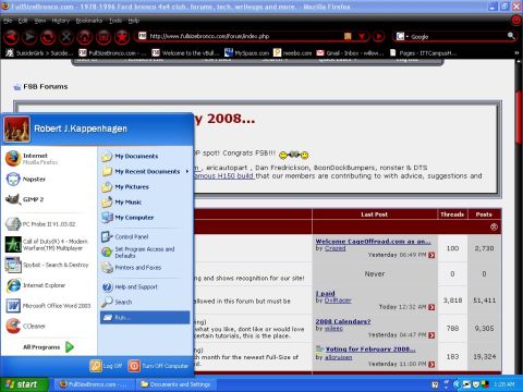 1993 Ford Bronco - A computer screen shows a forum website with a Windows start menu open, displaying various applications and system options.