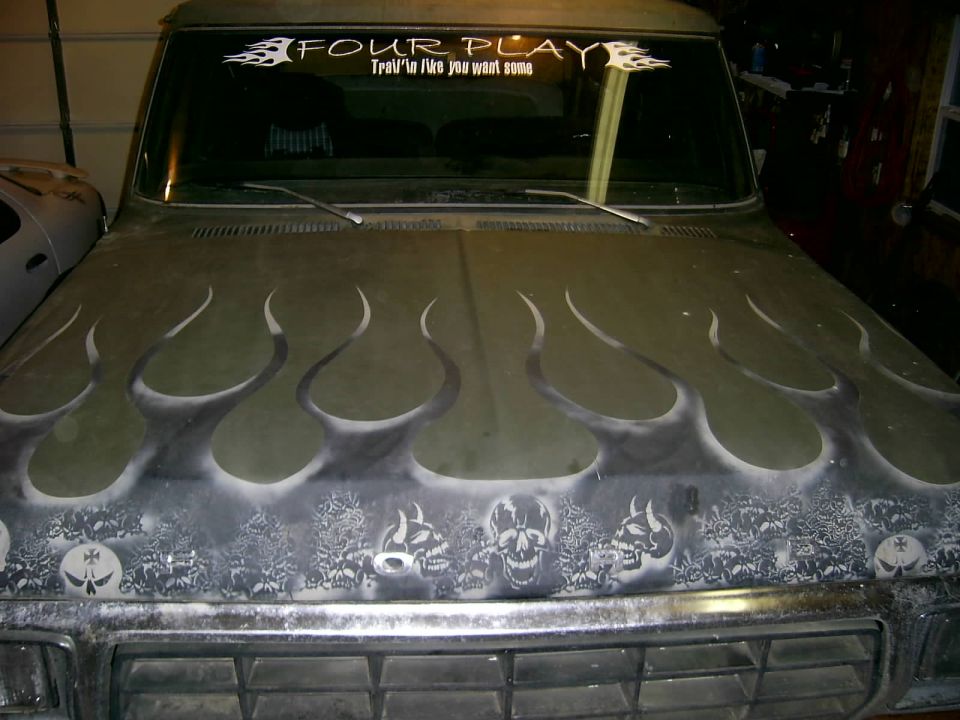 Truck hood with flame and skull airbrushing. Windshield banner says "FOUR PLAY"