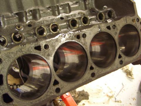 1996 Ford Bronco - The internal cylinders of an engine block are visible, showing signs of use and lubrication.