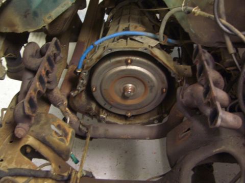 1996 Ford Bronco - Close-up view of a vehicle's transmission and exhaust system components.