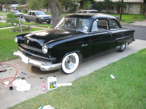 1953 Ford Mainline - This black 1953 Ford Mainline sedan features classic whitewall tires and chrome accents.