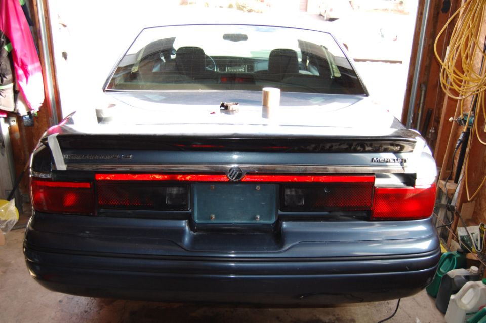 Rear of a dark blue Mercury Grand Marquis LS sedan in a garage