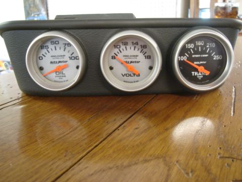 2000 Ford Crown Victoria - A set of three Auto Meter gauges, including oil pressure, voltage, and transmission temperature, are mounted in a black housing.