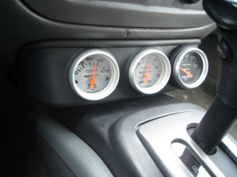2000 Ford Crown Victoria - Aftermarket gauges for oil pressure, voltage, and transmission temperature are installed in the vehicle's dashboard.