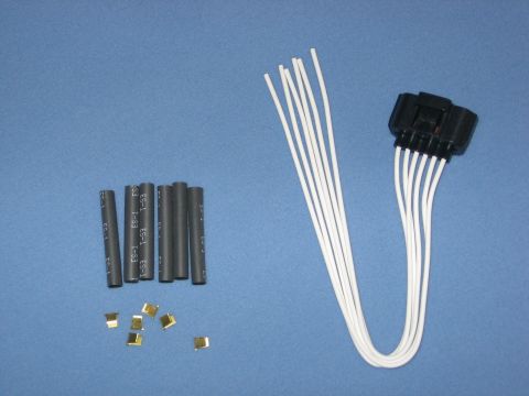 2000 Ford Crown Victoria - This image shows a wiring harness repair kit, including a connector, white wires, and black heat shrink tubing with brass terminals.