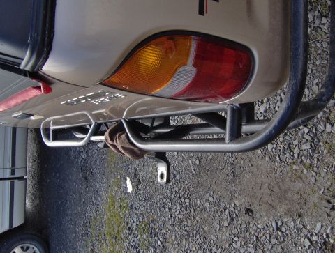 1978 Ford Bronco - Close-up of a vehicle's rear bumper, showing a custom roll cage and tow hitch.