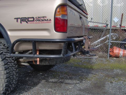 1978 Ford Bronco - The rear of a Toyota truck is shown, a custom bumper and a TRD Off Road decal.