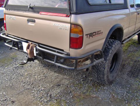 1978 Ford Bronco - Rear view of a Toyota Tacoma pickup truck an aftermarket bumper and TRD Off Road badging.