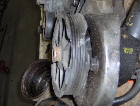 1978 Ford Bronco - This image shows a close-up of engine components, specifically a pulley and part of a power steering pump, with visible wear and damage.