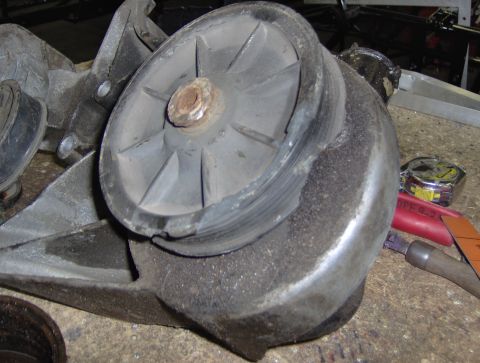 1978 Ford Bronco - Close-up of a worn serpentine belt tensioner pulley, showing damage to the rubber and metal components.