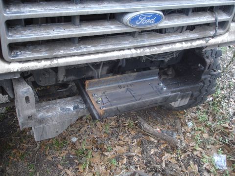 1989 Ford Bronco - Custom winch mount fabricated and bolted to the front of a Ford truck, with 'Back' and an arrow marked on the metal.