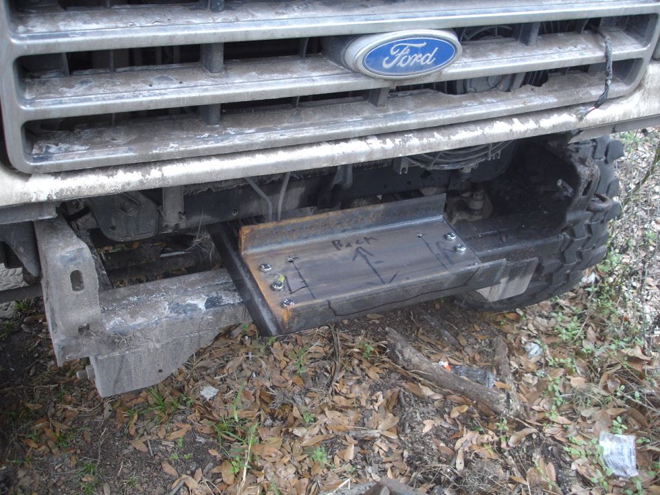 Custom winch mount bolted to front of Ford truck grille