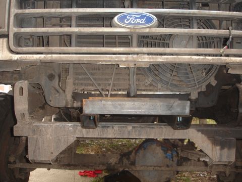 1989 Ford Bronco - Front view of a Ford truck showing the grille, radiator, and a custom fabricated part mounted to the frame.