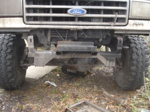 1989 Ford Bronco - Front view of a Ford truck with a custom winch mount and large off-road tires, suggesting an earlier model year.