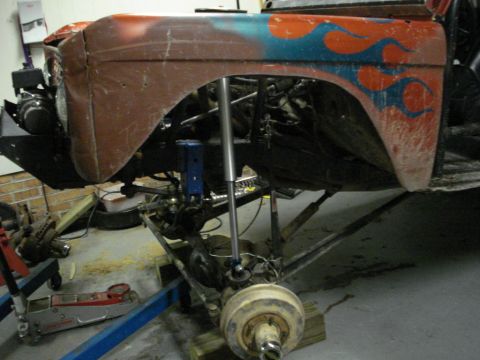 1992 Ford Mustang - This vehicle is undergoing modifications with its suspension and engine exposed.