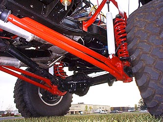 1991 Ford Bronco - Custom suspension parts and a large tire are visible in this detail shot.