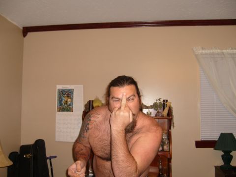 1995 Ford Bronco - A man is shown indoors making an offensive gesture with his finger.