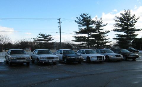 1988 Mercury Grand Marquis - Several sedans are parked in a lot on a cloudy day, including a 1988 Mercury Grand Marquis.