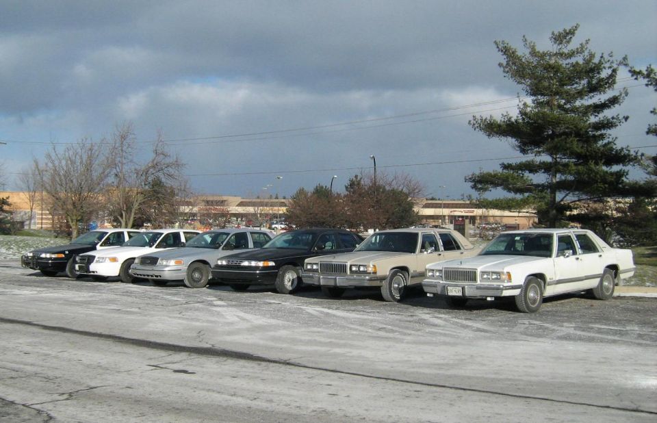 White 1988 Mercury Grand Marquis parked in a line with other sedans
