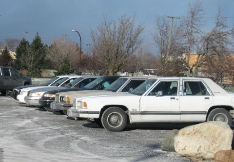 1988 Mercury Grand Marquis - A row of 1988 Mercury Grand Marquis sedans parked in a lot during winter.
