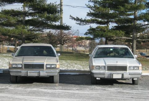 1988 Mercury Grand Marquis - Two 1988 Mercury Grand Marquis sedans are shown parked outdoors on a cloudy day.