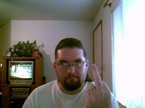 1993 Ford Bronco - A man poses for a photo while giving the middle finger, with a television visible in the background.